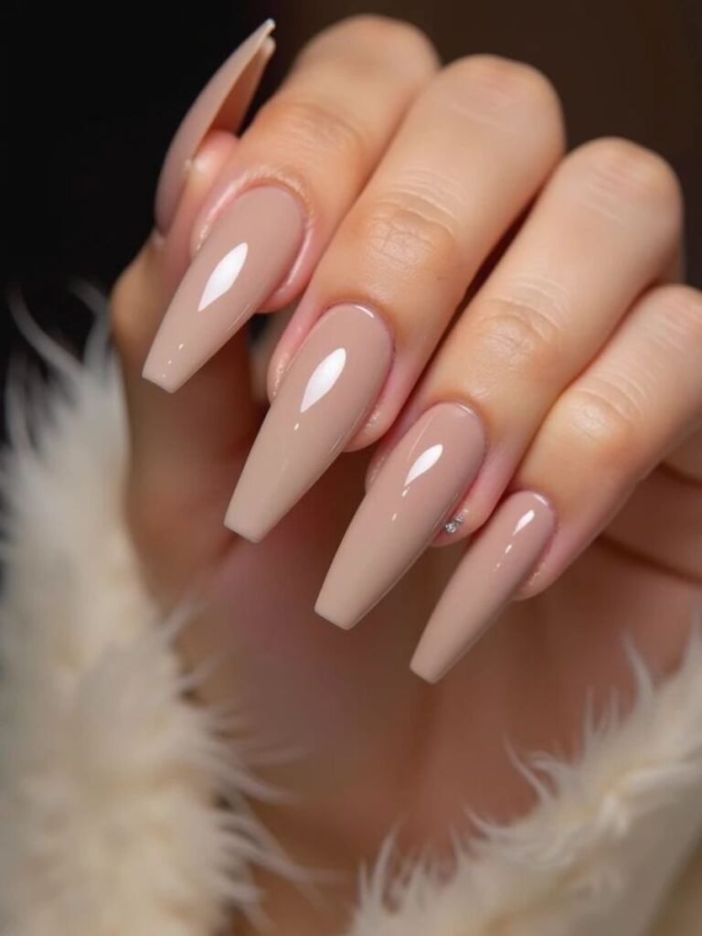 long acrylic nails in coffin shape with nude pink color on white background